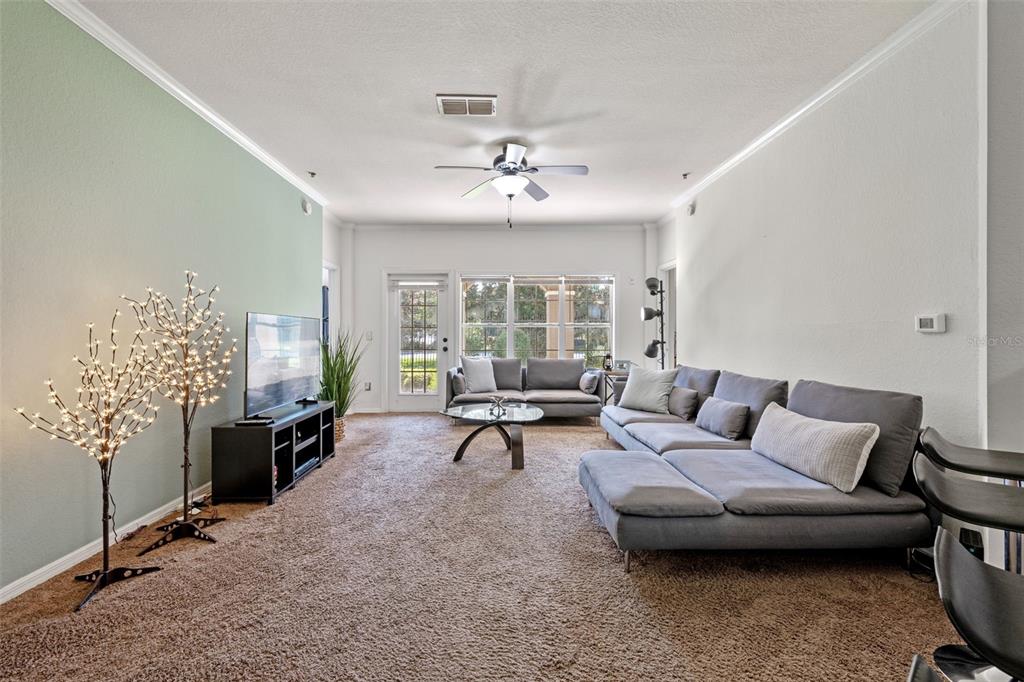 3701 Conroy Road, Unit 1812 Orlando, FL 32839 - Photo 6 of 37 a living room with furniture and windows