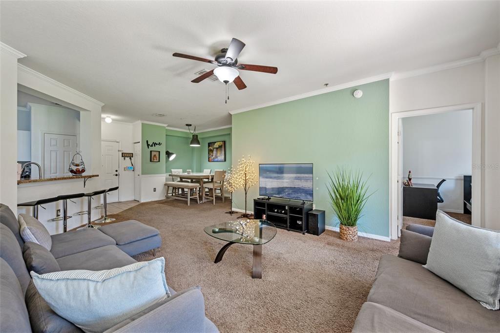 3701 Conroy Road, Unit 1812 Orlando, FL 32839 - Photo 9 of 37 a living room with furniture and a gym machine