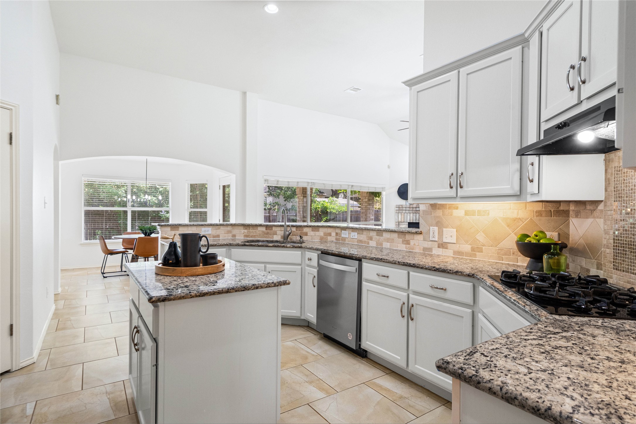 2920 Warwick Way Austin, TX 78748 - Photo 14 of 36 An open-concept kitchen with high ceilings and a central island flows into a well-lit dining area, perfect for daily living