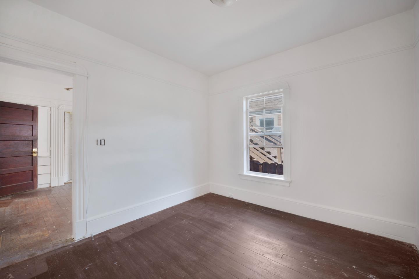 674 South 5th Street San Jose, CA 95112 - Photo 14 of 32 an empty room with wooden floor and windows