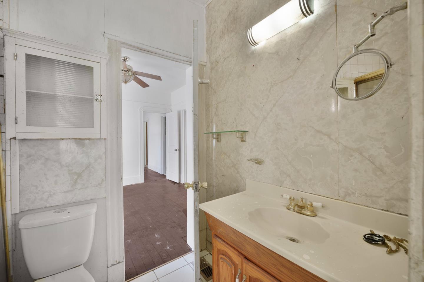 674 South 5th Street San Jose, CA 95112 - Photo 15 of 32 a bathroom with a sink and a mirror