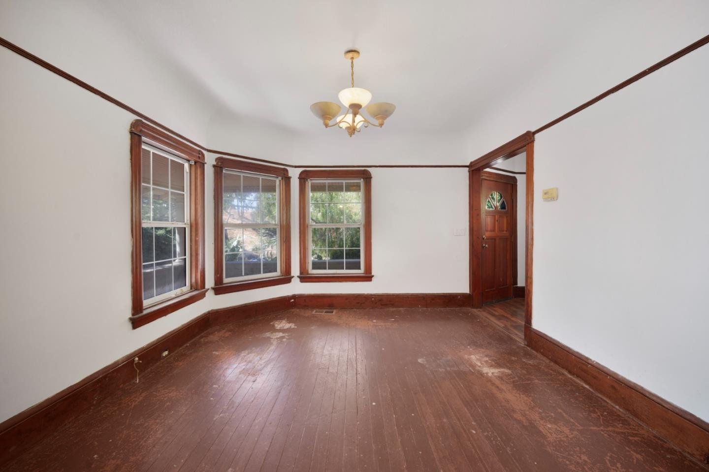 674 South 5th Street San Jose, CA 95112 - Photo 7 of 32 a view of an empty room with a window and wooden floor