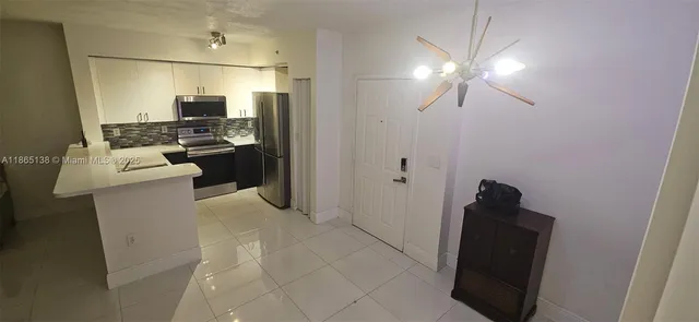 a room with a refrigerator and cabinets