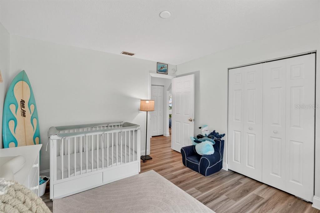 2012 Mango Tree Drive Edgewater, FL 32141 - Photo 11 of 36 a view of a bedroom with wooden floor and furniture