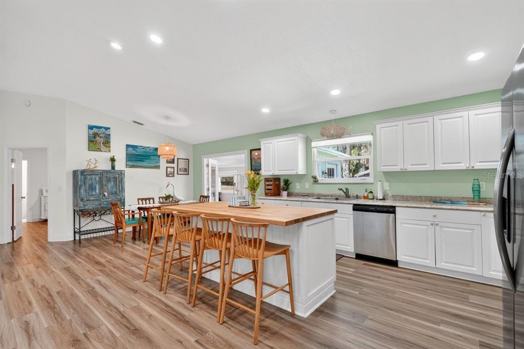 2012 Mango Tree Drive Edgewater, FL 32141 - Photo 16 of 36 a kitchen with stainless steel appliances a table and chairs in it
