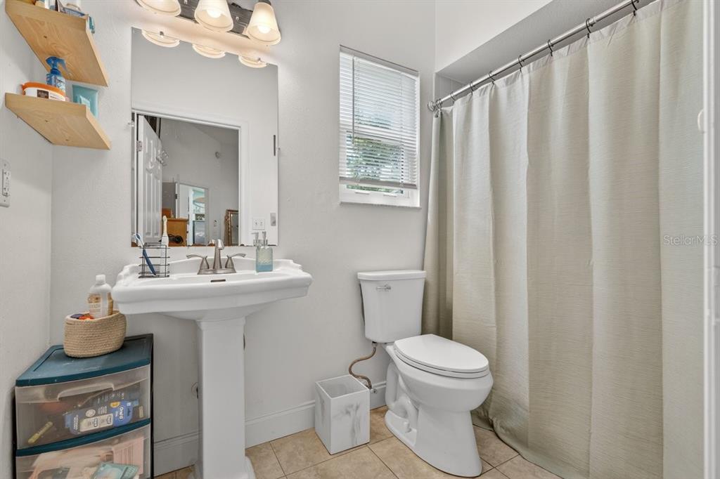 2012 Mango Tree Drive Edgewater, FL 32141 - Photo 22 of 36 a bathroom with a sink a toilet and mirror