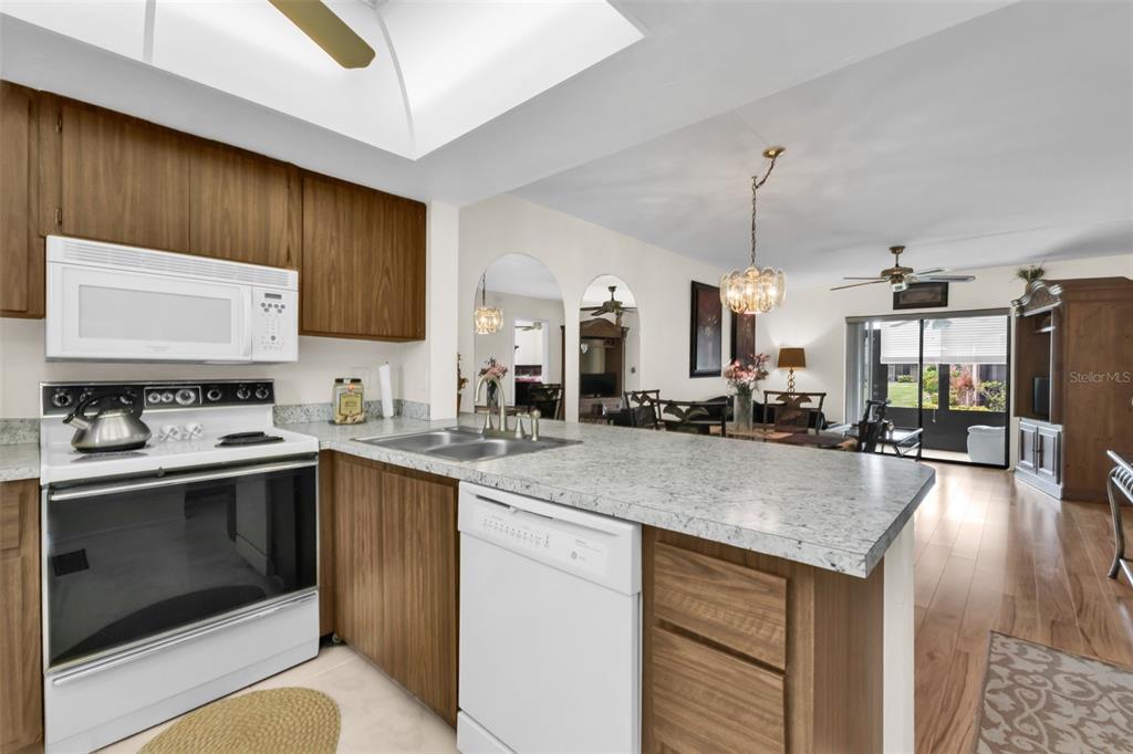 25225 Rampart Boulevard, Unit 1604 Punta Gorda, FL 33983 - Photo 12 of 41 a kitchen with stainless steel appliances granite countertop a sink stove and refrigerator