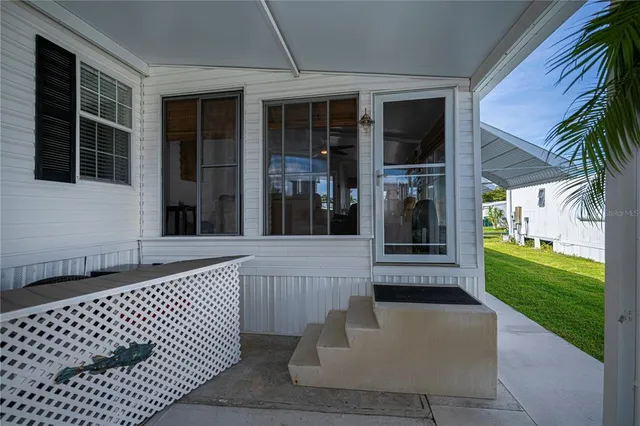 an aerial view of residential houses with outdoor space and lake view