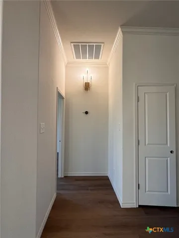 a view of an entryway with wooden floor