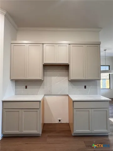 a kitchen with white cabinets and a sink