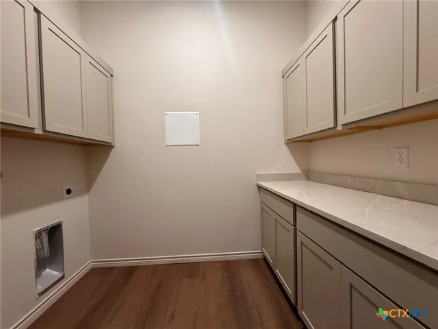 a view of storage and utility room with wooden floor
