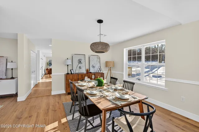 a view of a dining room with furniture window and wooden floor
