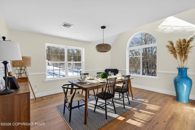 a view of a dining room with furniture window and wooden floor