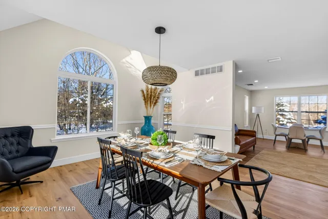 a view of a dining room with furniture window and wooden floor