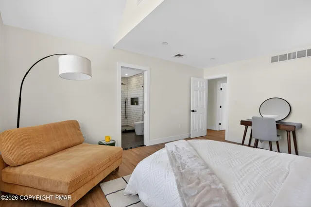 a bedroom with a bed and a mirror