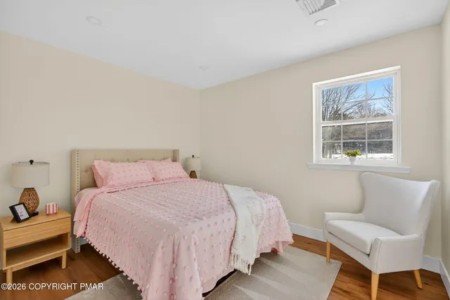 a bedroom with a bed and a couch