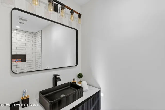 a bathroom with a sink and a mirror