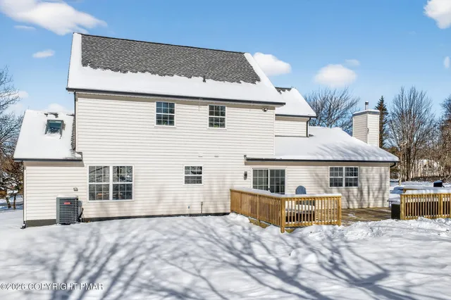 a view of a house with a patio and a yard