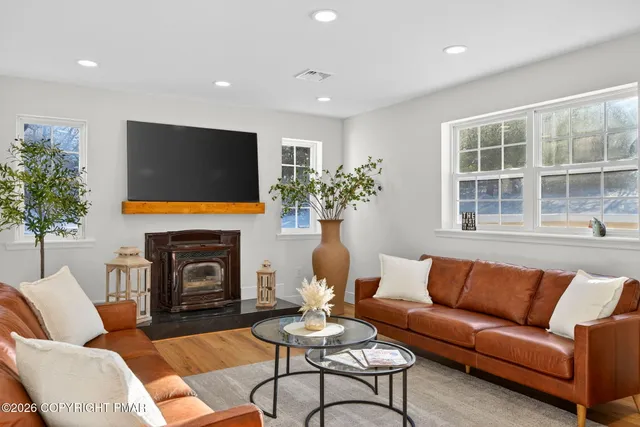 a living room with furniture a fireplace and a flat screen tv