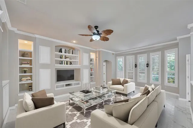 a living room with furniture and large windows