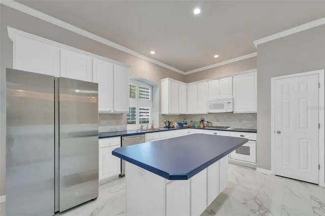 a kitchen with stainless steel appliances a refrigerator and a stove