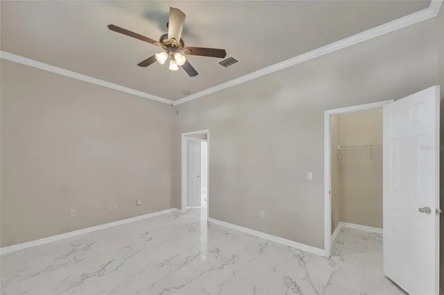 a bedroom with a bed and ceiling fan