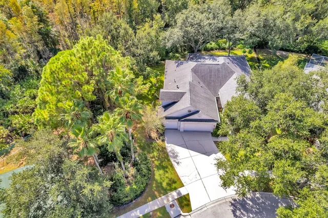 an aerial view of a house with a yard