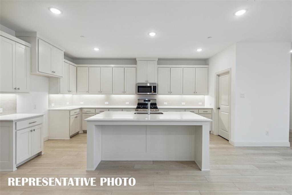 1015 Magdalena Way Midlothian, TX 76065 - Photo 5 of 16 The spacious island is the hub of this fantastic home! REPRESENTATIVE PHOTO