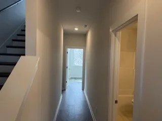 a view of a hallway with wooden floor and entryway