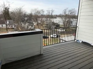 a view of a balcony with wooden fence and floor