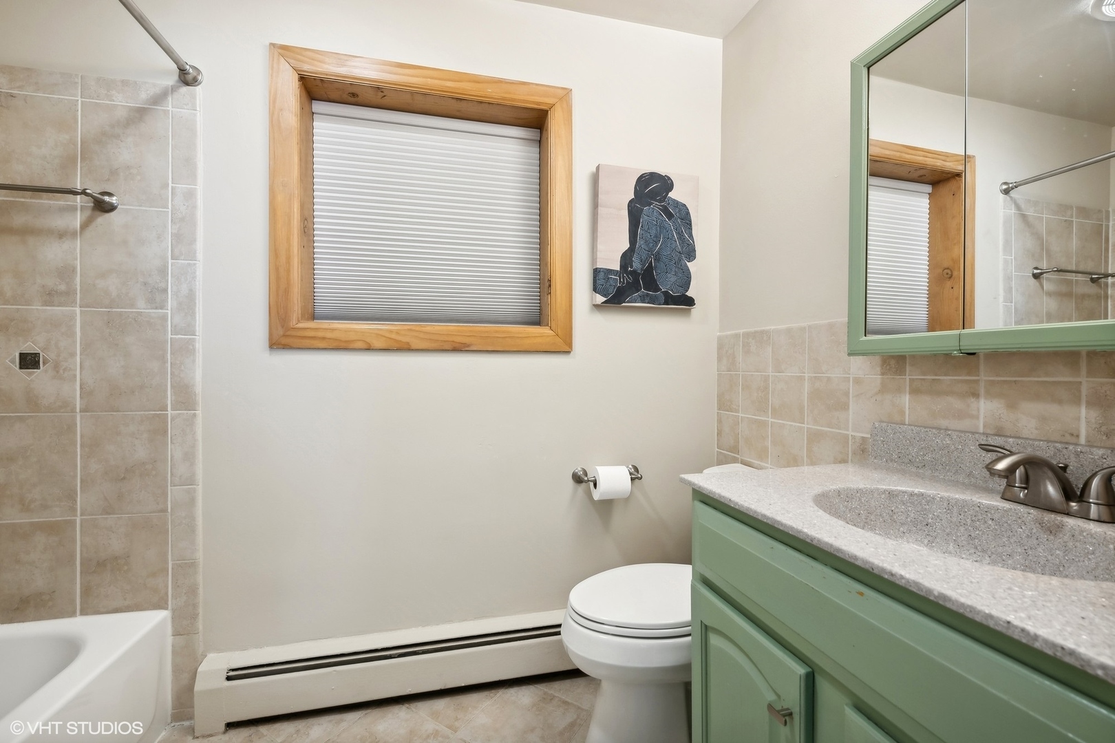 1127 West Erie Street, Unit 1C 1C Chicago, IL 60642 - Photo 16 of 18 a bathroom with a sink a toilet and shower
