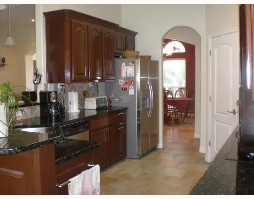 a kitchen with a refrigerator and cabinets