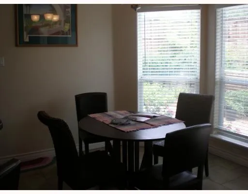 a view of a dining room with furniture and window