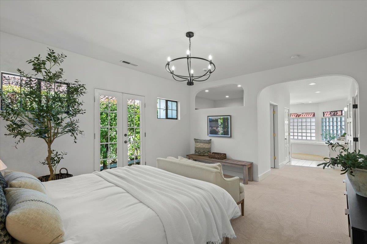 731 5th Street Gilroy, CA 95020 - Photo 14 of 30 a bedroom with a large bed and a chandelier