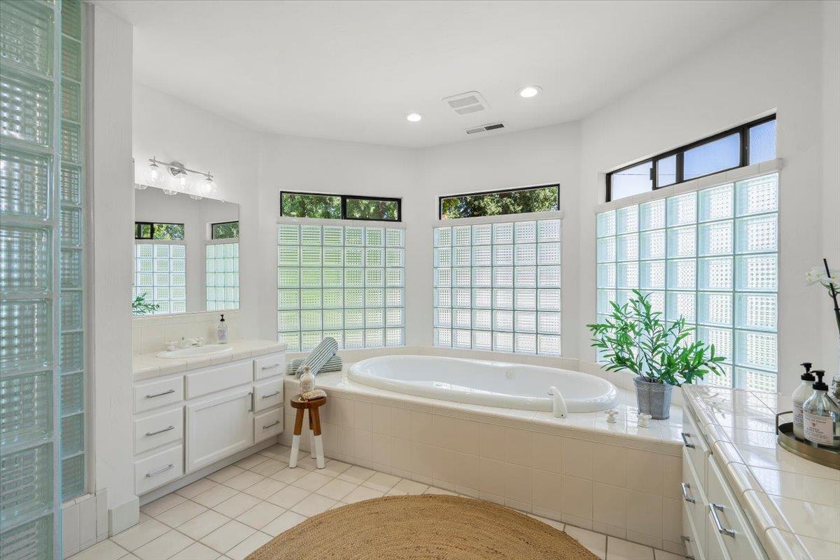 731 5th Street Gilroy, CA 95020 - Photo 18 of 30 a bathroom with a bathtub and a shower