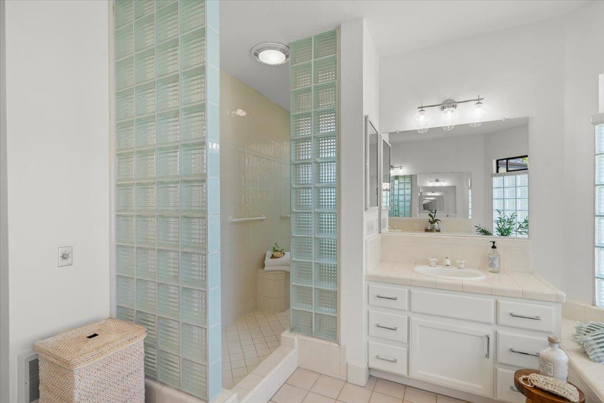 731 5th Street Gilroy, CA 95020 - Photo 19 of 30 a bathroom with a shower sink and mirror