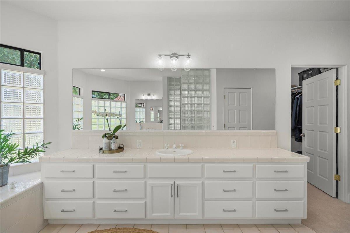 731 5th Street Gilroy, CA 95020 - Photo 20 of 30 a bathroom with a granite countertop sink mirror and double