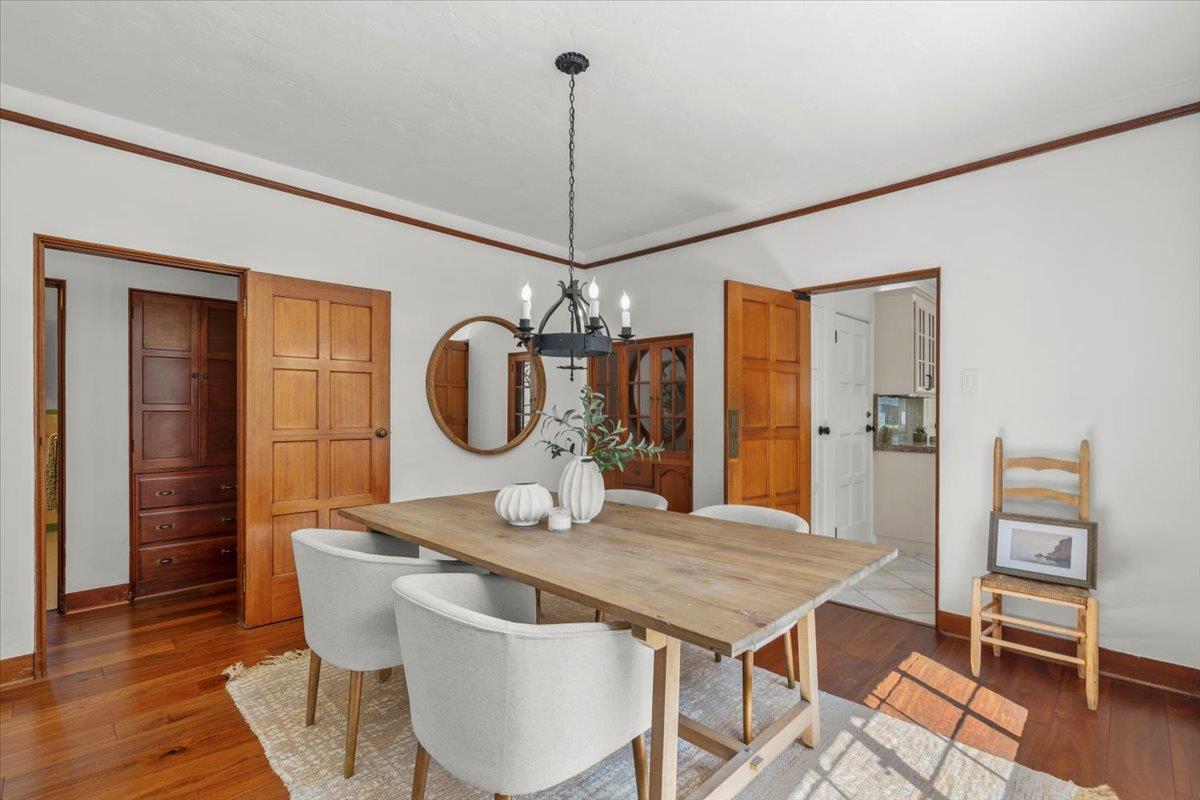 731 5th Street Gilroy, CA 95020 - Photo 6 of 30 a dining room with wooden floor a chandelier a wooden table and chairs