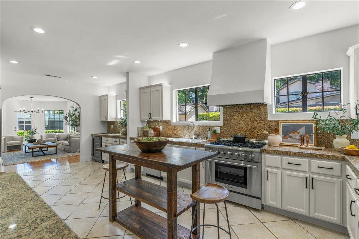 731 5th Street Gilroy, CA 95020 - Photo 7 of 30 a kitchen with a stove a sink a dining table and chairs