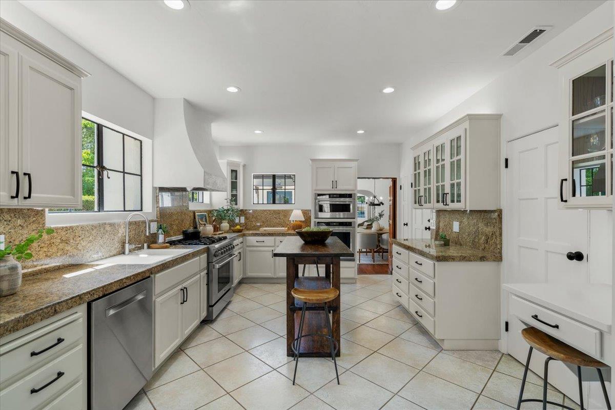 731 5th Street Gilroy, CA 95020 - Photo 9 of 30 a kitchen with stainless steel appliances kitchen island granite countertop a sink and cabinets
