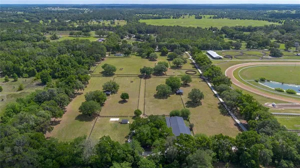 a view of a street with a house in the background