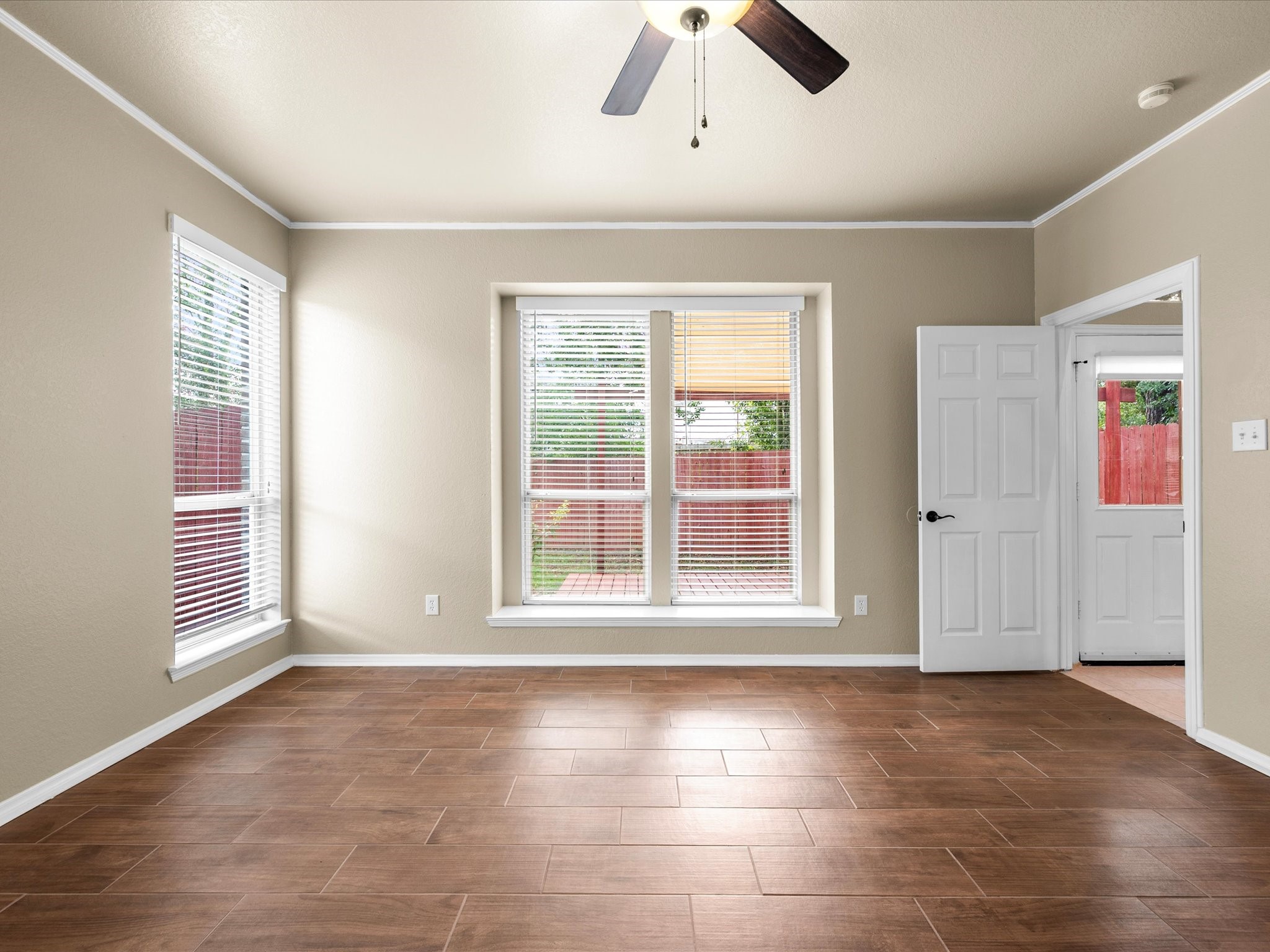 291 Sunset Path South Conroe, TX 77316 - Photo 19 of 39 Wood-look tile floors complement the peaceful atmosphere of this serene primary retreat, creating a comfortable space to unwind.