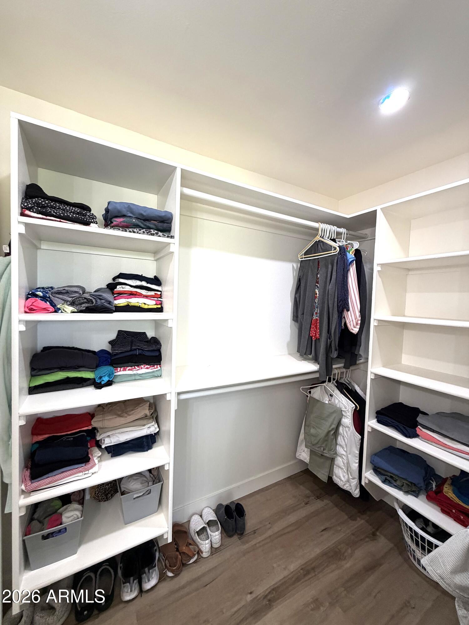 9936 West Mountain View Road Sun City, AZ 85351 - Photo 12 of 21 a view of walk in closet with clothes and shoes