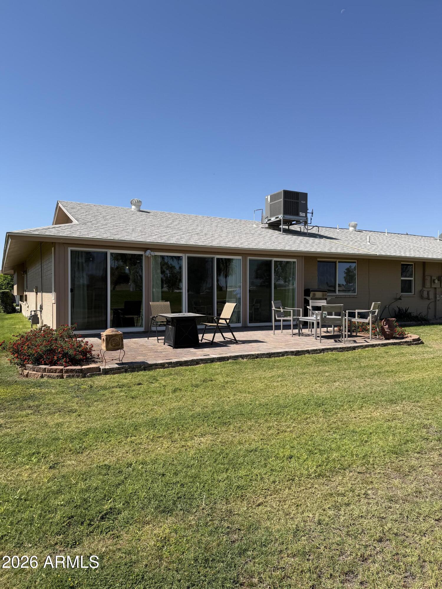 9936 West Mountain View Road Sun City, AZ 85351 - Photo 19 of 21 a view of a house with swimming pool and a yard