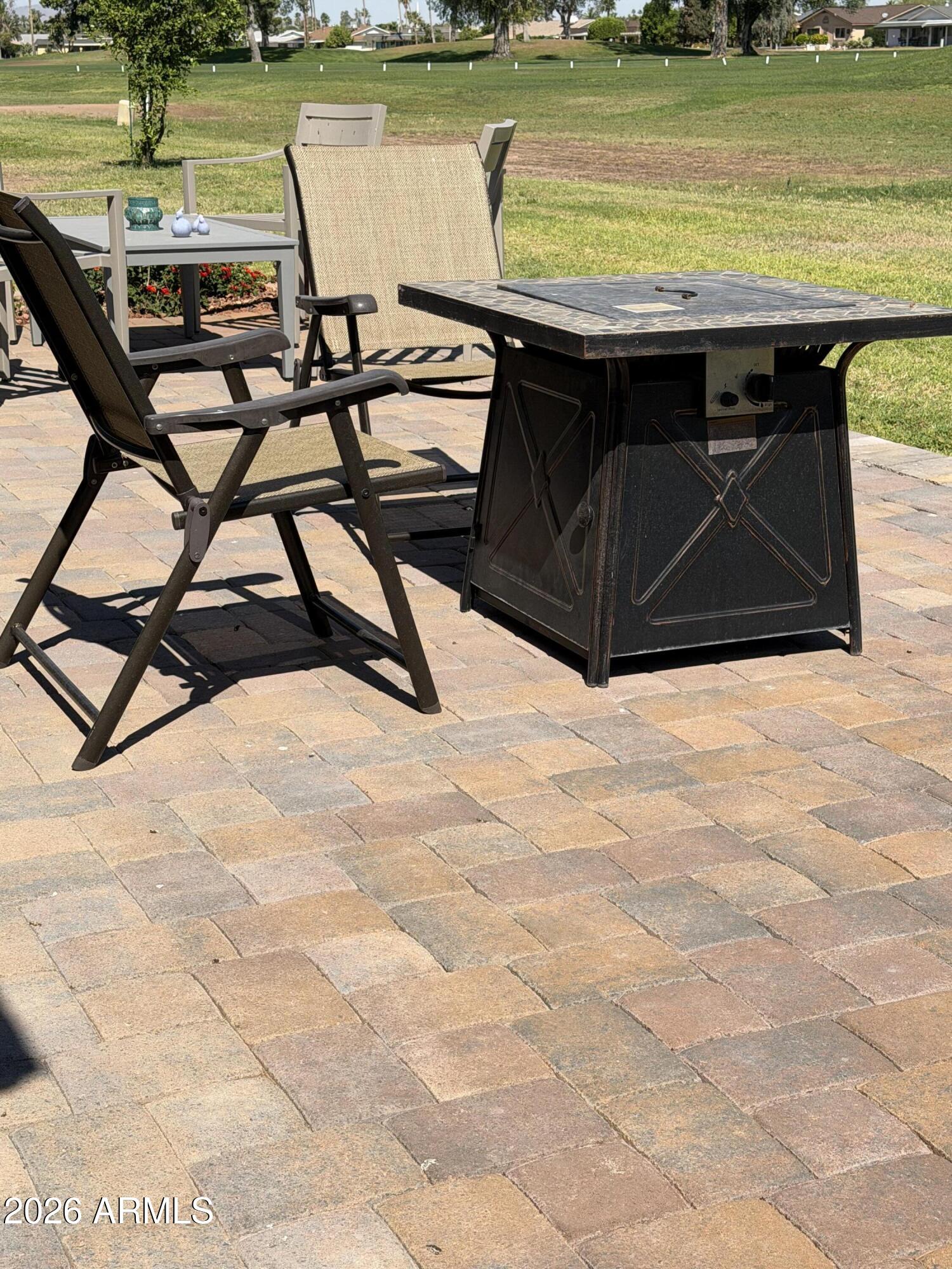 9936 West Mountain View Road Sun City, AZ 85351 - Photo 20 of 21 a view of a terrace with chairs and lake view