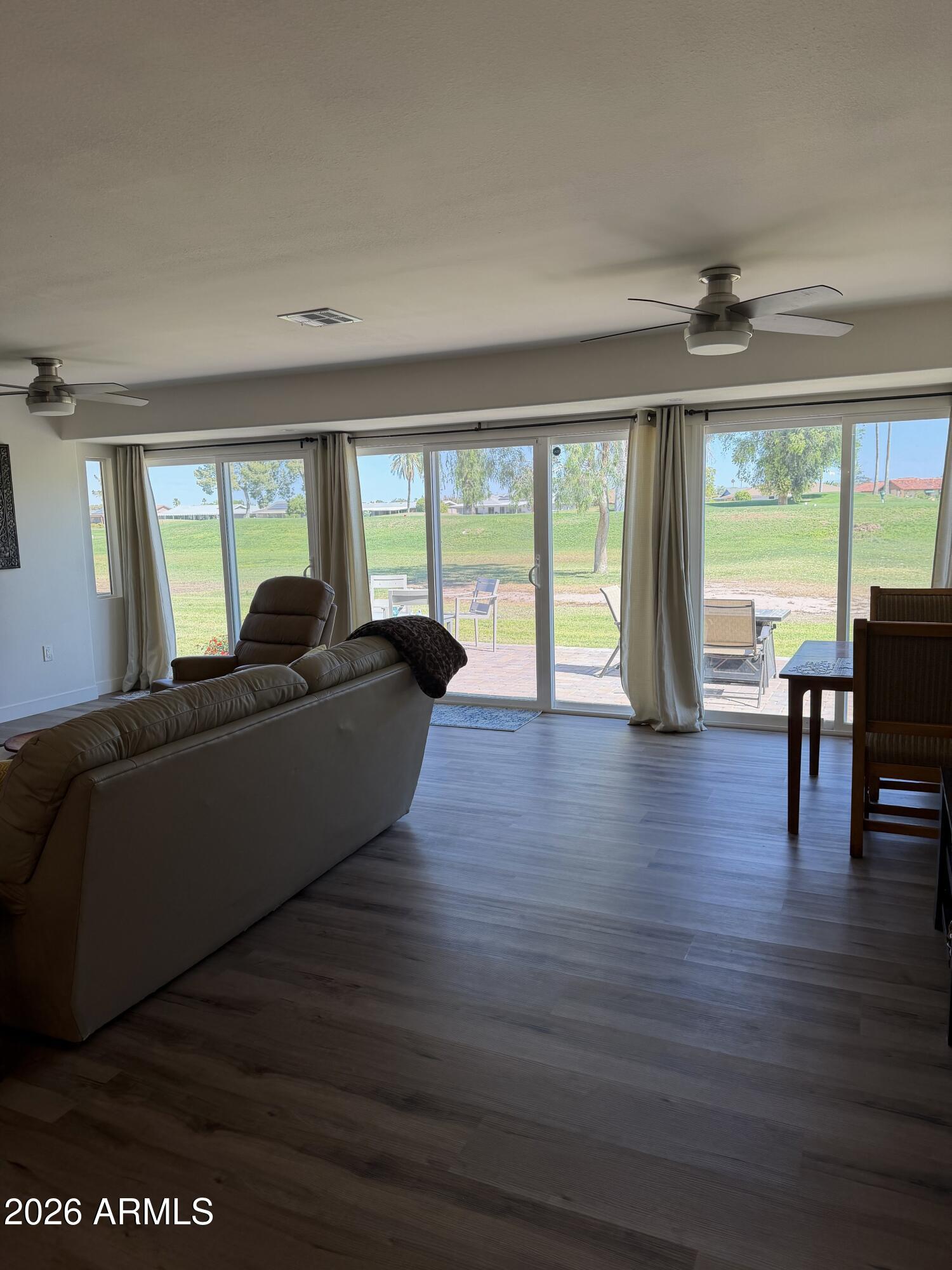 9936 West Mountain View Road Sun City, AZ 85351 - Photo 8 of 21 a living room with furniture and a large window