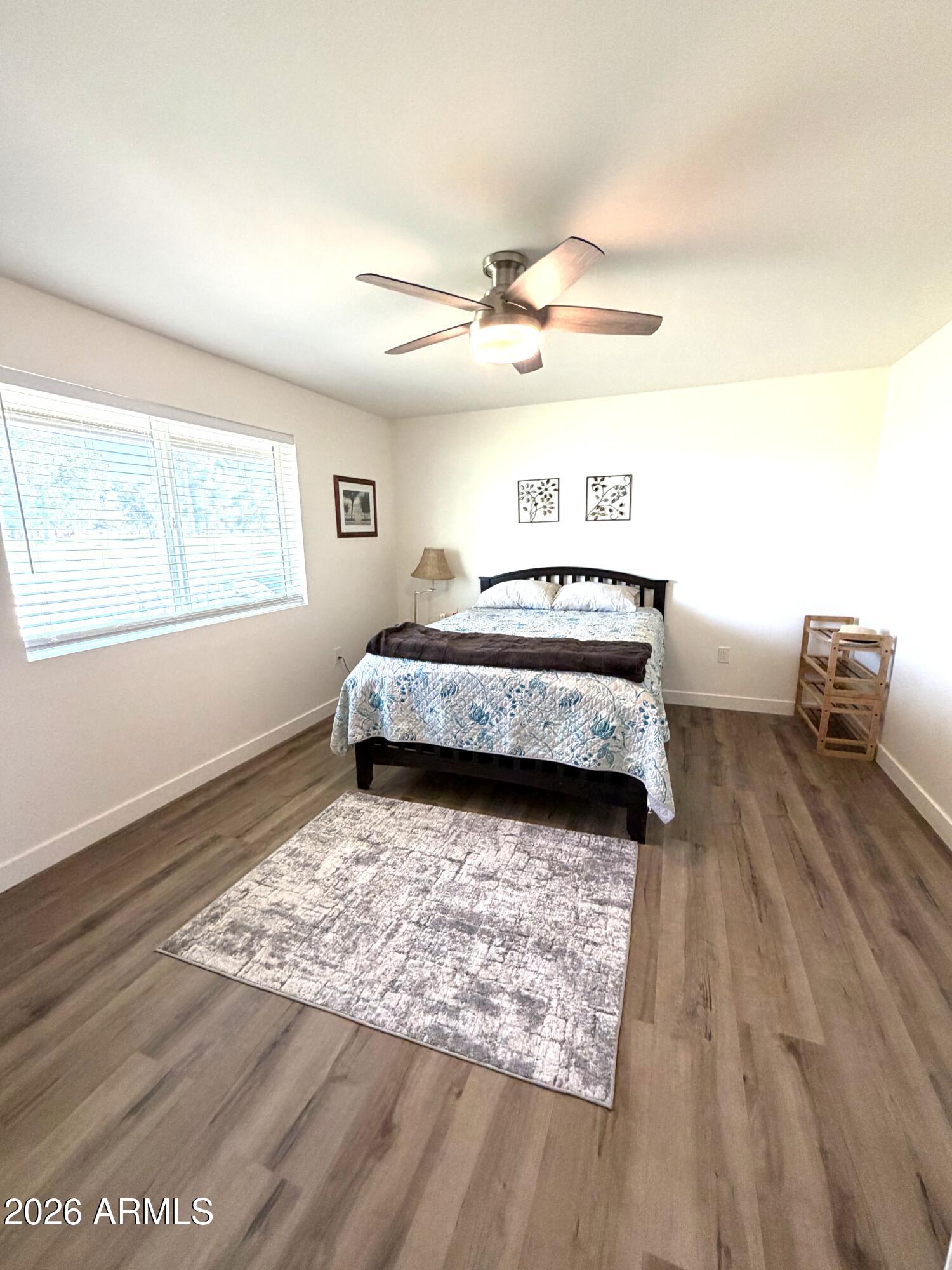 9936 West Mountain View Road Sun City, AZ 85351 - Photo 9 of 21 a spacious bedroom with a bed and a window