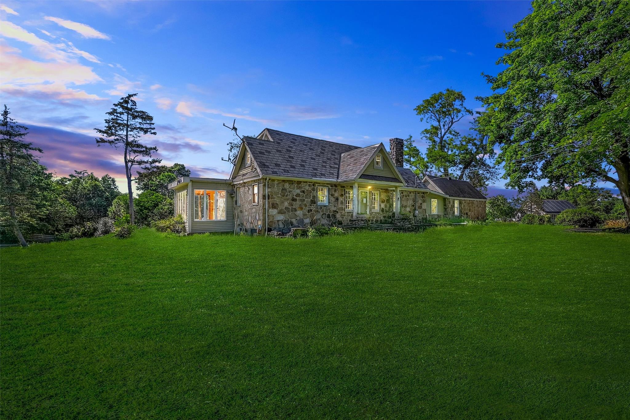 a front view of a house with a garden