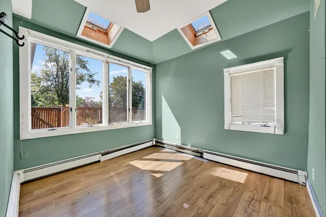 a view of empty room with wooden floor