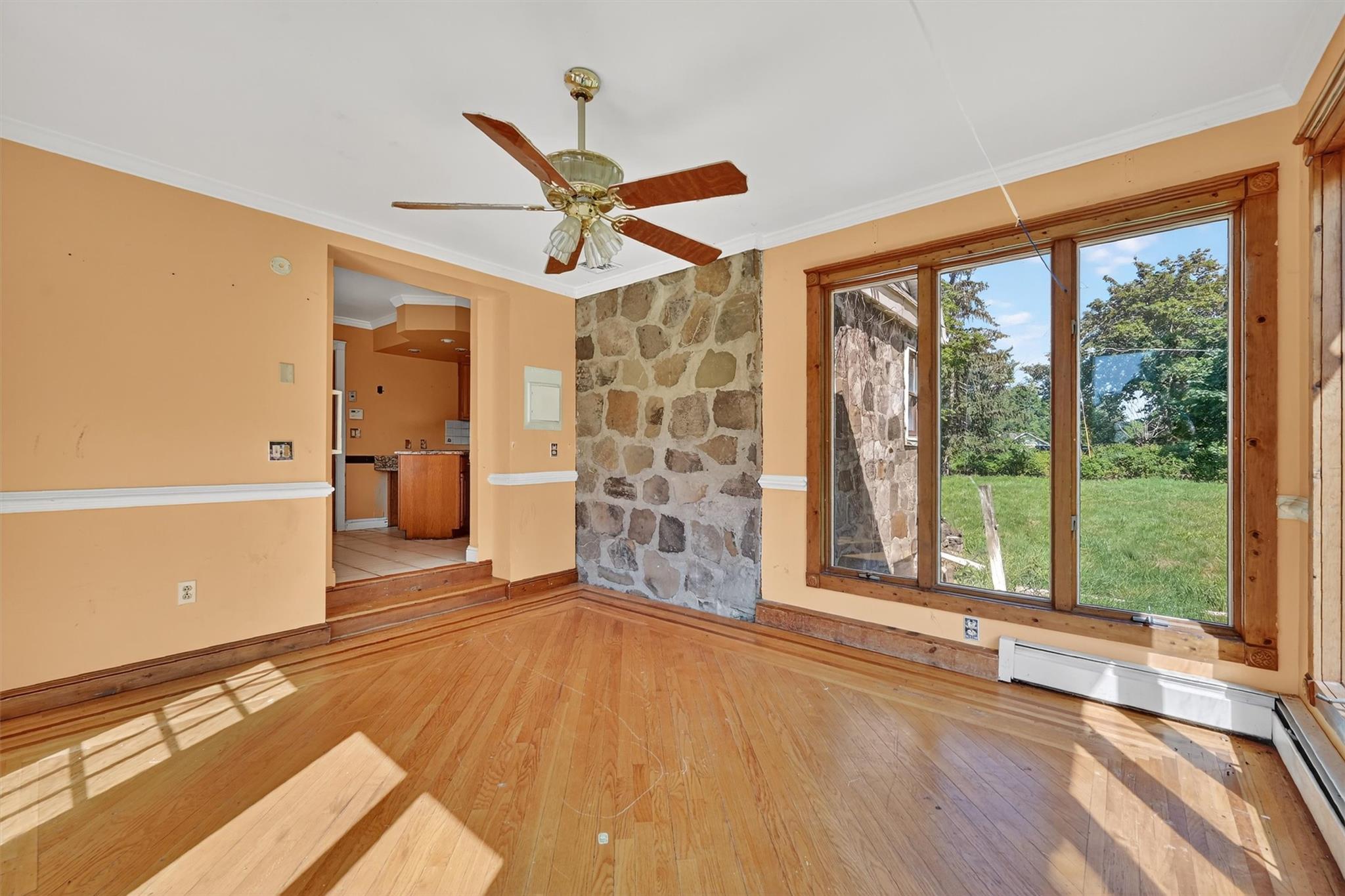 151 Tuthill Road Blooming Grove, NY 10914 - Photo 18 of 49 a view of an empty room with a window and wooden floor